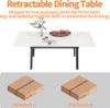 A retractable dining table with decorative items on it, and two shipping boxes below. Produktbild-Vorschau