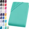 A stack of folded fitted sheets in various colors, with one sheet prominently displayed in mint green. Produktbild-Vorschau