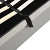 A close-up view of the slatted base of a bed frame, showing the wooden slats and black straps that hold them in place, resting on a gray bed frame. Podgląd zdjęcia produktu