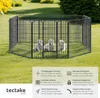 Three Labrador puppies in a black metal playpen on a grassy lawn. Produktbild-Vorschau