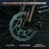 Close-up of a bicycle's mechanical disc brake system against a dark background. Produktbild-Vorschau