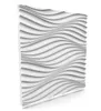 A white 3D wall panel with a wavy, undulating surface. Produktbild-Vorschau