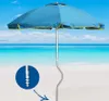 A blue beach umbrella with yellow trim is set up on a sandy beach with the ocean and sky in the background. A close-up inset shows the screw-in base of the umbrella pole. Anteprima dell’immagine prodotto