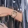 A person's arm wearing a rose gold Casio G-Shock watch against a shiny silver background. Voir les images du produit