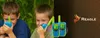 Two young boys playing with walkie-talkies outdoors. Anteprima dell’immagine prodotto