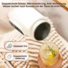 A hand pours hot water from a white electric travel kettle into a glass with lemon and herbs. Produktbild-Vorschau