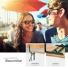 A couple enjoying themselves outdoors at a table with umbrellas. Produktbild-Vorschau