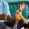 A person is holding a Woody action figure from Toy Story. Náhľad obrázku produktu