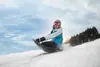 A person is sledding down a snowy hill. Produktbild-Vorschau