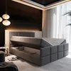 A bedroom scene with a bed that has its storage compartment open. Produktbild-Vorschau
