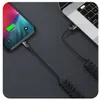 A coiled USB-C cable connects a smartphone to a laptop. Anteprima dell’immagine prodotto