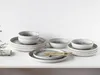 A set of stoneware dishes with a speckled gray and white glaze and a rustic brown rim, arranged on a white surface. Náhľad obrázku produktu