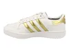 A side view of a white Adidas sneaker with gold stripes. Produktbild-Vorschau
