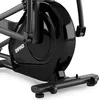 A close-up view of the black flywheel and base of an elliptical trainer. Podgląd zdjęcia produktu