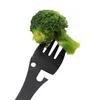 A close-up of a black multi-tool fork holding a piece of broccoli. Produktbild-Vorschau