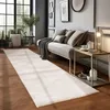 A modern living room with a long runner rug, a sofa with pillows, and a side table with a lamp and tea set. Anteprima dell’immagine prodotto