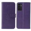 A purple flip phone case with a floral and butterfly embossed design is shown open and closed. Produktbild-Vorschau