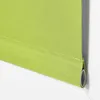 A close-up view of the bottom edge of a green roller blind, showing the fabric and the roller mechanism. Produktbild-Vorschau