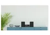 A stereo system with two speakers and a central unit is placed on a blue cabinet, next to a potted plant and decorative bowls. Anteprima dell’immagine prodotto