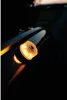 A close-up of a portable work light attached to a car roof rail at dusk. Produktbild-Vorschau