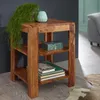 A wooden side table with shelves, decorated with a plant, a vase, a decorative box, and books, placed in a living room setting. Podgląd zdjęcia produktu