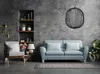 A living room scene with a sofa, armchair, shelves, and a pendant lamp. Produktbild-Vorschau