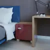 A bedroom scene with a bed, nightstand, and desk. Produktbild-Vorschau
