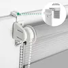 Close-up of a roller blind mechanism attached to a window frame, with a diagram showing measurement. Produktbild-Vorschau