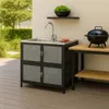An outdoor kitchen setup with a sink and a grill. Produktbild-Vorschau
