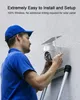 A man in a blue cap and shirt is installing a white security camera with a solar panel on a textured wall. Náhled obrázku produktu