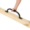 A hand is holding a black handle attached to a wooden beam. Anteprima dell’immagine prodotto