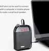 A portable speaker is connected to a laptop via an AUX wire, with text describing its functionality. Produktbild-Vorschau