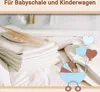 A stack of white cotton cloths with a decorative dried grass stalk, and a cartoon illustration of a baby stroller with balloons. Produktbild-Vorschau
