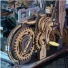 Close-up view of a wooden mechanical model with gears and a crank. Podgląd zdjęcia produktu