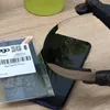 A smartphone screen protector is being applied to a smartphone. The packaging for the screen protector is visible on the left. Produktbild-Vorschau