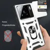 A hand is holding a white and black phone case with a silver ring holder on the back. The phone case has a camera protection cover that is open. Produktbild-Vorschau