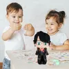Two children are playing with a Harry Potter plush toy on a table. Anteprima dell’immagine prodotto