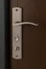 A close-up shot of a door handle and lock mechanism mounted on a wooden door. Náhľad obrázku produktu