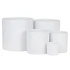 A group of five white ceramic cylinder planters of varying sizes are arranged together against a white background. Produktbild-Vorschau