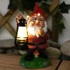 A garden gnome holding a lantern, standing on a grassy mound with a mushroom. Produktbild-Vorschau