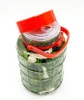 A glass jar filled with cucumbers and other ingredients, with a red lid. Produktbild-Vorschau