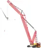 A large red crane is lifting a wind turbine blade. Produktbild-Vorschau