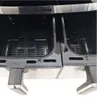 Close-up view of the interior of a dual-chamber air fryer, showing the two baskets. Produktbild-Vorschau