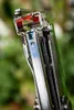 A close-up shot of the top of a stapler, showing the staple loading mechanism and part of the green handle. Náhľad obrázku produktu