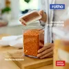 A person is holding the lid of a clear food storage container filled with orange lentils. Produktbild-Vorschau