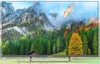 A television displaying a scenic mountain landscape with autumn foliage. Anteprima dell’immagine prodotto