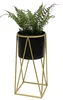 A potted fern plant on a gold geometric stand. Anteprima dell’immagine prodotto