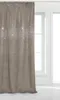 A beige velour curtain with sparkling crystals is shown hanging next to a window. Podgląd zdjęcia produktu