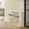 A white shoe cabinet with mirrored doors is shown in a hallway next to a door and a sofa. Produktbild-Vorschau