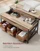 A lift-top coffee table with storage baskets underneath, shown in a living room setting. Produktbild-Vorschau